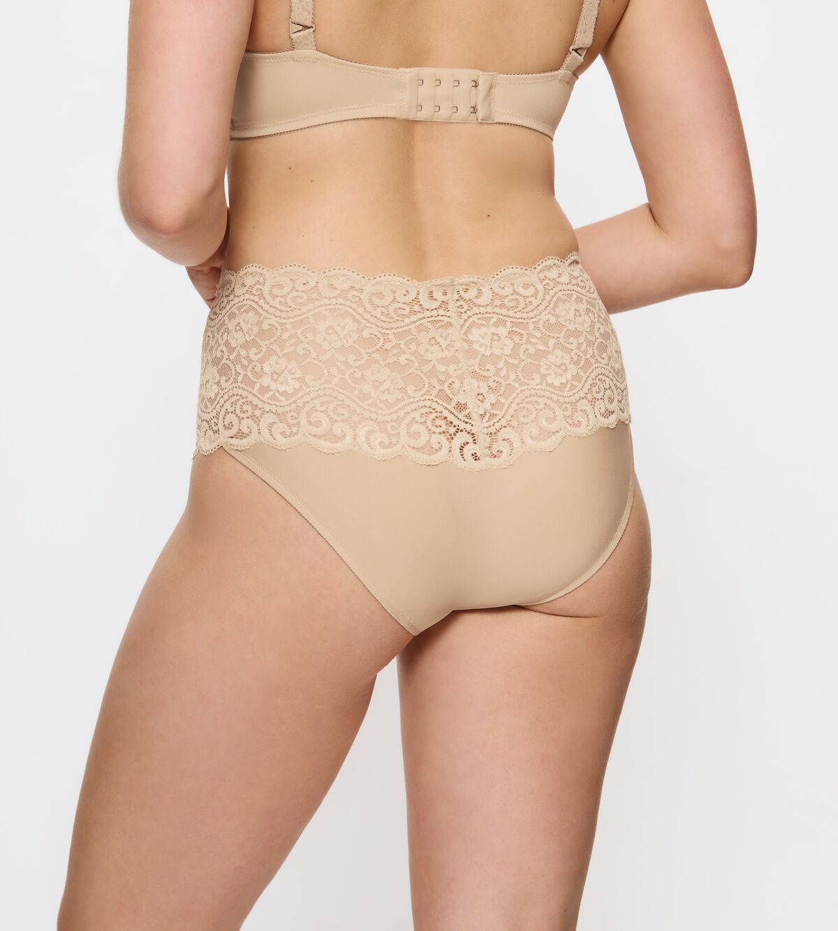 Model iført Triumph Amourette 0026 Pudder-sæt, fotograferet bagfra foran en ensfarvet baggrund.
